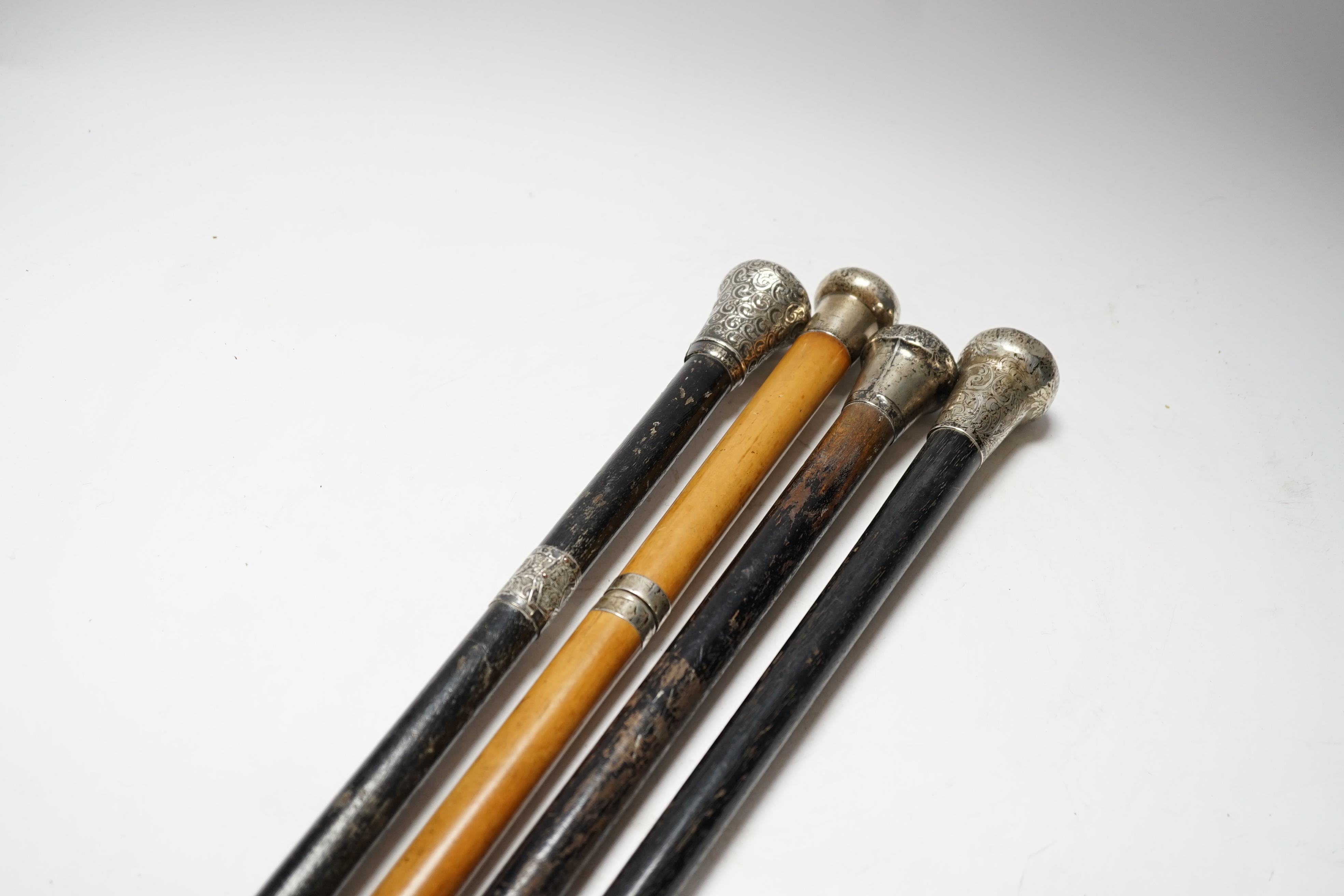 Four Victorian silver mounted handled walking sticks: one being a sword stick, sword stick 90cm long